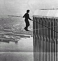 It was on August 7, 1974 that 24 year old Frenchman Philip Petit climbed into and up the then-unfinished Twin Towers, strung a wire, and used a balance beam (he smuggled the wire and the beam into and up the tower) to conduct a daredevil tightrope walk, back and forth a number of times, between the as-yet-unoccupied towers of the World Trade Center.